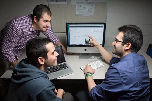 Computing graduate students work on the Web application. Pictured are Ehsan Valizadeh, David Qorashi and Sam Serpoosh.