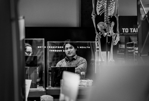  A person looks at a skeleton in a museum. 