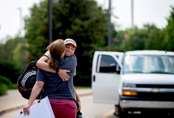 Matt Engbers hugs his mom, Andrea Engbers, in Allendale after the Water in the West team returned on June 7. 