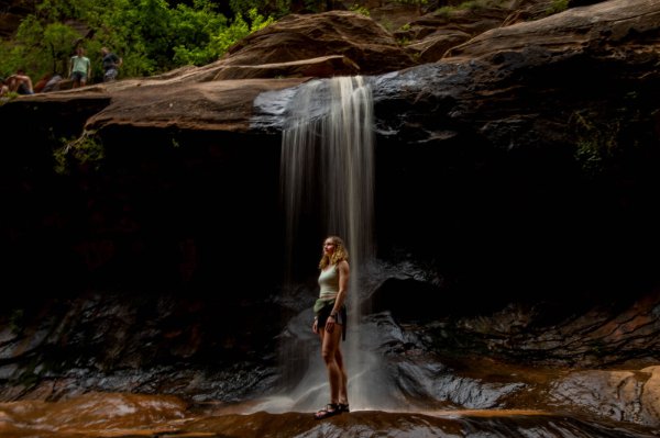 Ashtyn Gluck stands in front of a waterfall in Water Canyon. 
