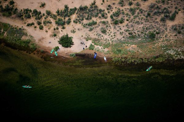 A photo of several kayaks in the river, taken from the Horseshoe Bend overlook. 