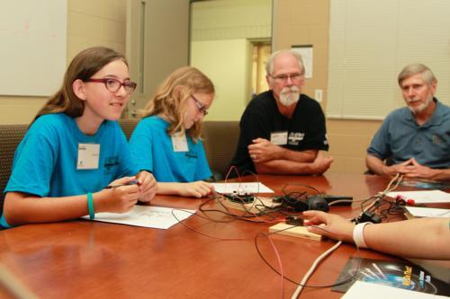 From left, two campers, Ron Grew and Ross Reynolds during the camp activity. 