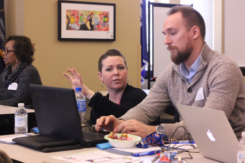 A Charter Schools Office staff member works with a teacher on professional development.