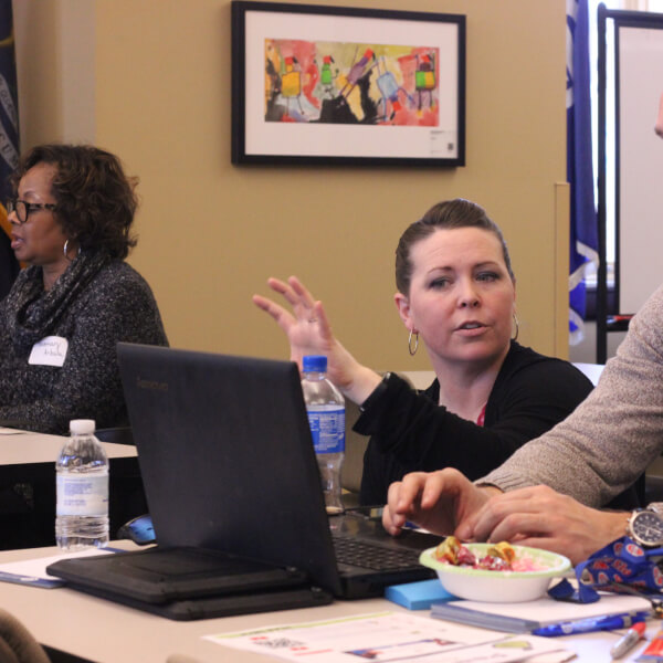 A Charter Schools Office staff member works with a teacher on professional development.