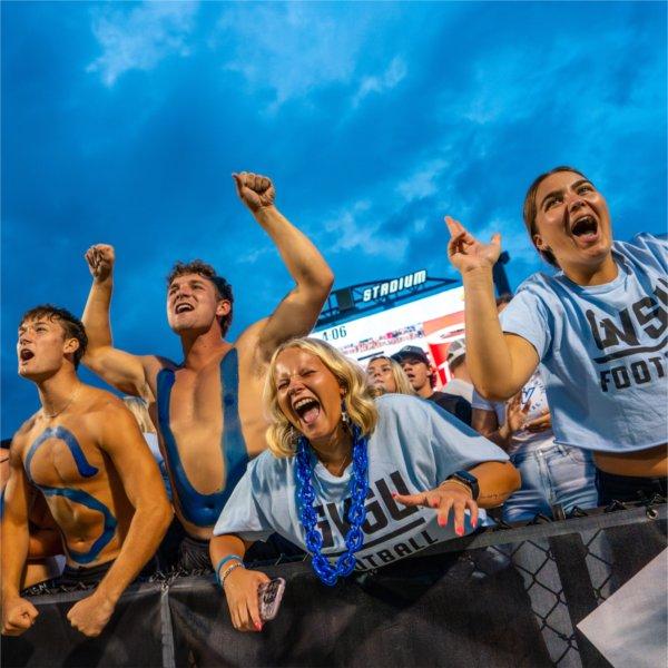 Students cheer at a GVSU Football game.