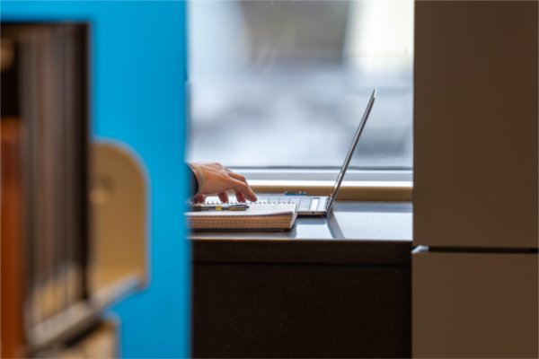 A student types on their laptop at the Mary Idema Pew Library.
