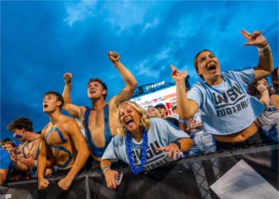 Students cheer at a GVSU Football game.