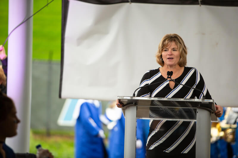 woman on stage behind podium