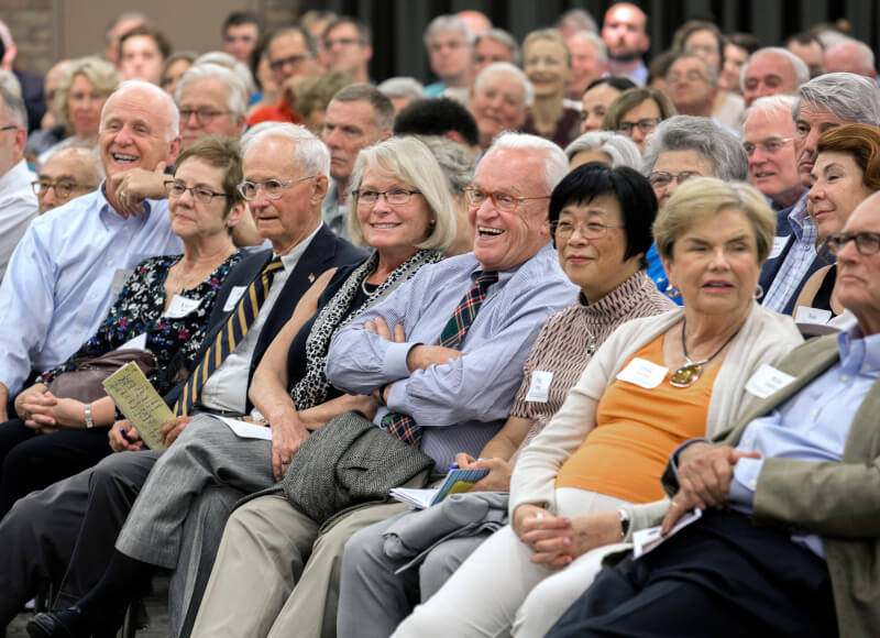 crowd members react to david brooks and ronald c. white on stage