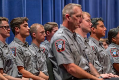 Police academy graduates take part in the Police Academy Graduation Ceremony at the Louis Armstrong Theatre on August 21.