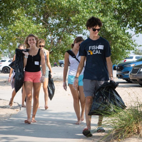 Student volunteers clean up a beach