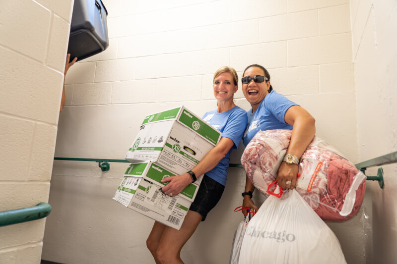 a volunteer helping move in students.