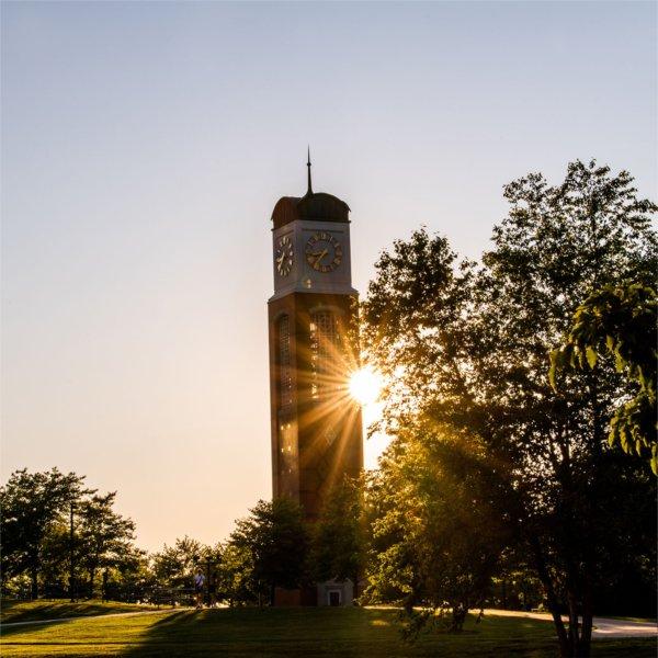 Cook Carillon tower with sunlight peaking behind it