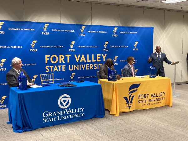 Officials from GVSU and FVSU sitting at a table during a signing agreement at FVSU.