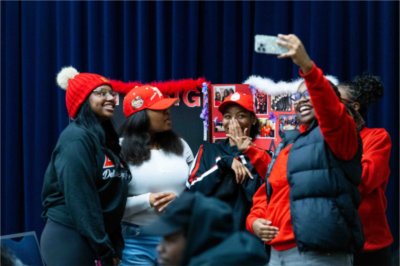 Members of Delta Sigma Theta pose for a selfie photo in the Mary Idema Pew Library atrium during the Blackout showcase.