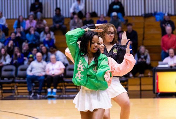  Sorority sisters dance on the gymnasium basketball floor during halftime. 