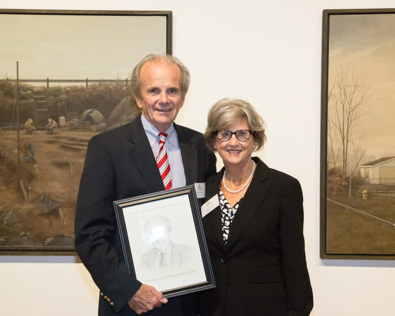 Norman Christopher and wife Anita Christopher with his West Michigan Hall of Fame portrait after the induction ceremony at UICA