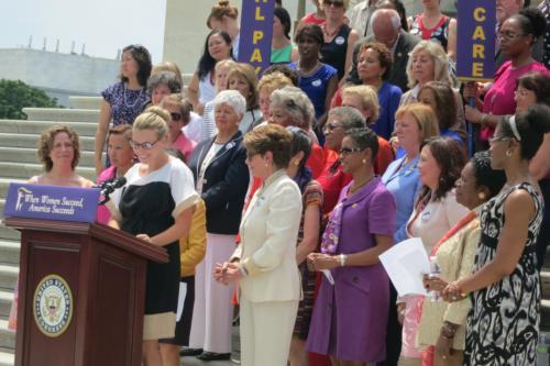 Stephanie Brown stands at the podium next to Nancy Pelosi during an event to promote the Women's Economic Agenda.