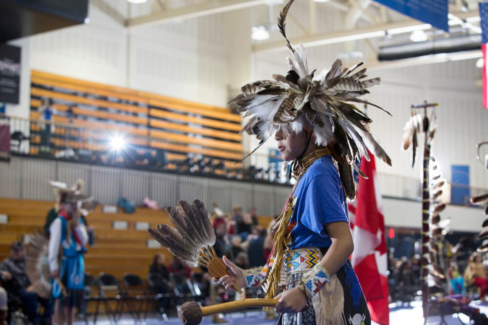 A photo of a person participating in the annual Pow Wow at Grand Valley.