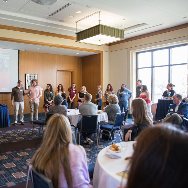 group of people waiting in line at front of room