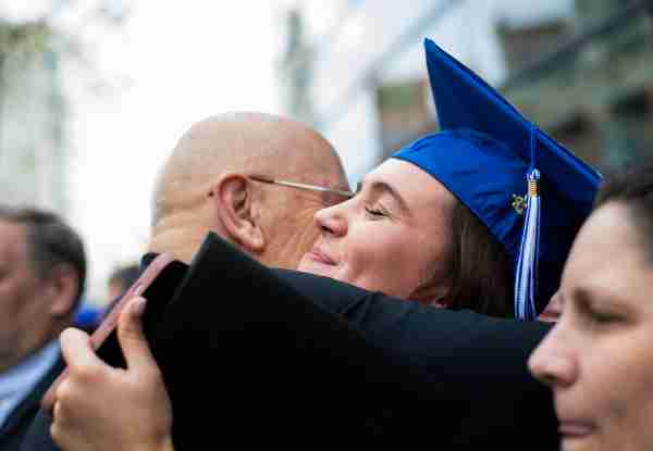 A grad hugs a family member after the ceremony.