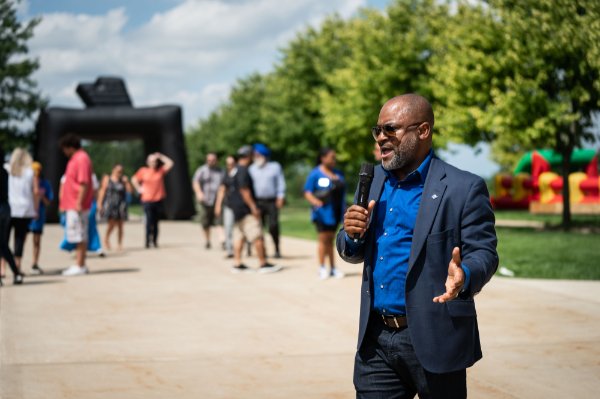 B. Donta Truss, vice president for Enrollment Development and Education Outreach, talks into a microphone outside to a crowd
