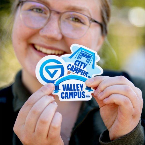 Tyleur Wright, a sophomore nursing student, poses with free sticker swag she picked up during the gvsYOU debut brand launch event at the Cook Carillon Tower September 30.