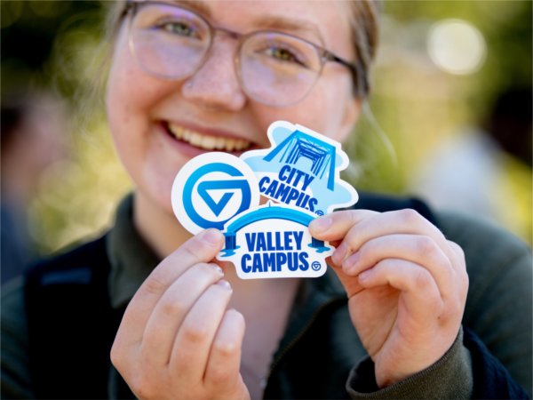Tyleur Wright, a sophomore nursing student, poses with free sticker swag she picked up during the gvsYOU debut brand launch event at the Cook Carillon Tower September 30.
