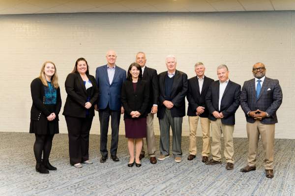 From left are Lyndsey Schab, Samantha Mayse, Thompson Foundation trustees John Cleary, Cathy Kunkel, Joe Aristeo, Brian Cooney, Kevin Brender and Curt Little, and B. Donta Truss, vice president for Enrollment Development and Educational Outreach.