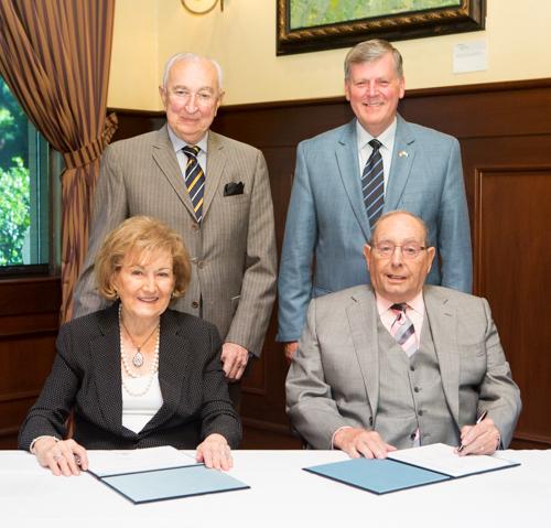 Richard and Helen DeVos (front row); Luis Tomatis, director of medical affairs for RDV Corporation; and Grand Valley President Thomas J. Haas celebrate the gift that will support the continuation of the DeVos Medical Ethics Colloquy, now at Grand Valley.
