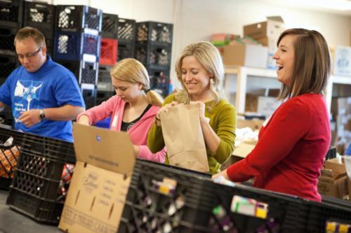 Volunteers pack sack meals at Kids' Food Basket in Grand Rapids during COW 2012. This year's outreach week is March 18-23.