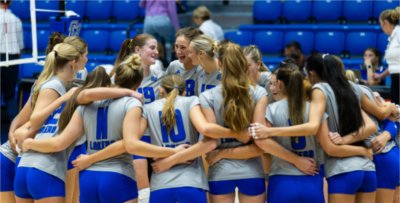 Gabby Orlet, Kennedy Arp and Finley Arp gather with teammates during a match against Northwood at the Hampton Inn and Suites Grand Rapids Downtown Classic on September 3, 2026.