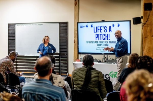 A man delivers a presentation to an audience. 