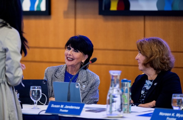 President Mantella and Board of Trustee Susan Jandernoa seated at the board table.