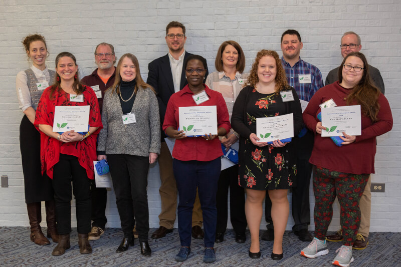 group of people in two rows holding certificates