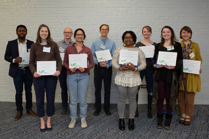 group of people holding certificates