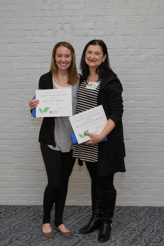 two women holding certificates