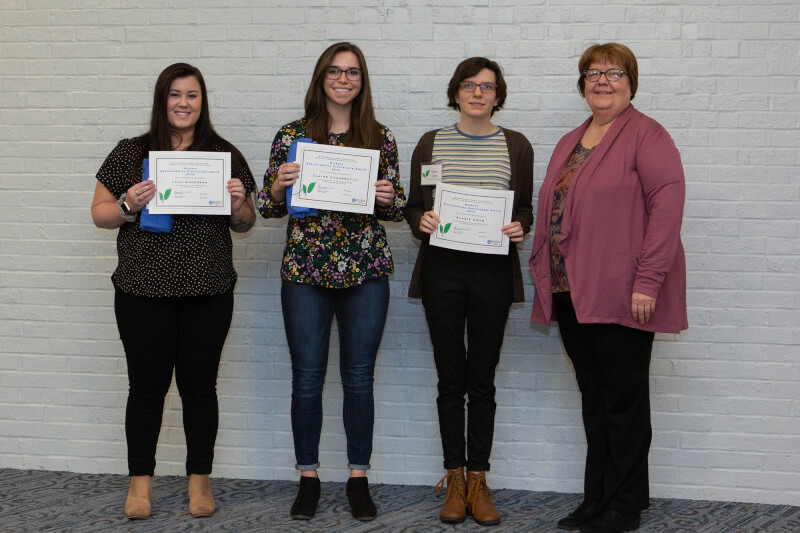 women holding certificates 