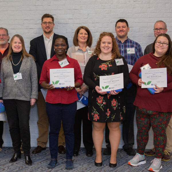 group of people in two rows holding certificates