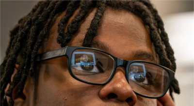 Video of MLK reflected in the eyeglasses of a young student