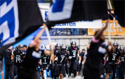 The Grand Valley State football team runs onto the field before the Battle of the Valleys game against Saginaw Valley State at Lubbers Stadium in Allendale, Michigan, on Oct. 18, 2025.