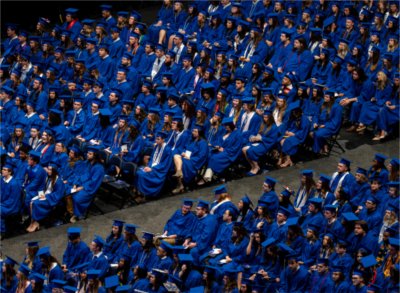 Graduates sit at Commencement ceremony.