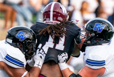 Grand Valley defenders surround a West Texas A&M player to make a tackle.