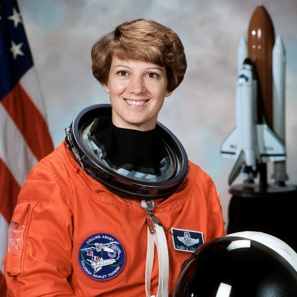 A portrait of Eileen Collins in her orange astronaut uniform
