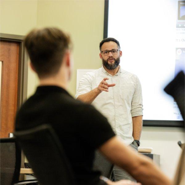 Daniel Williams speaks with a student during a class.