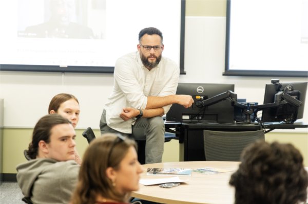 Daniel Williams listens to a student during their class at the Honors College. 