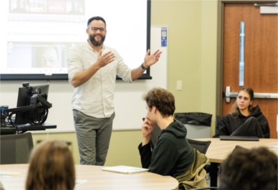 Daniel Williams leads his students in a discussion during their class at the Honor College.