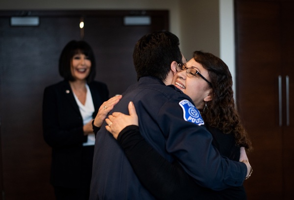 Marco Rojas-Garcia hugs his mother Tereza Garcia after he was sworn in by President Philomena V. Mantella.
