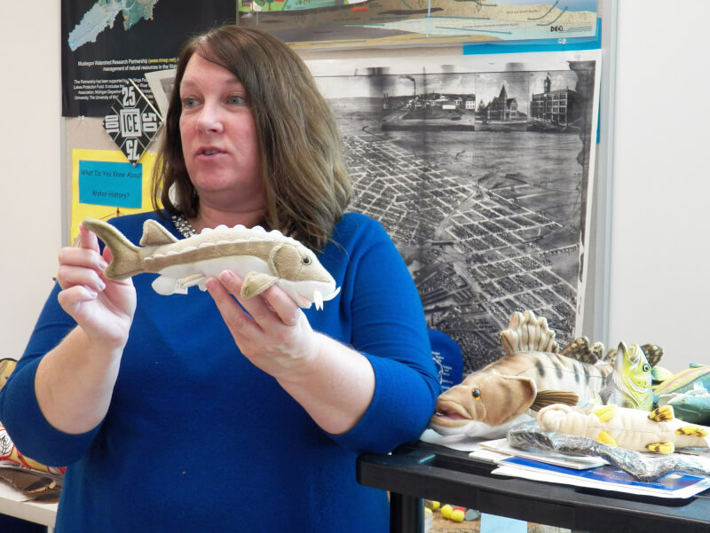 Sherry Claflin holds a stuffed fish while teaching a lesson in a classroom at AWRI.