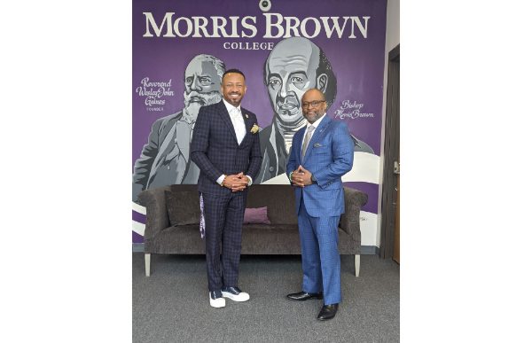 Kevin James and B. Donta Truss stand in front of a Morris Brown College mural